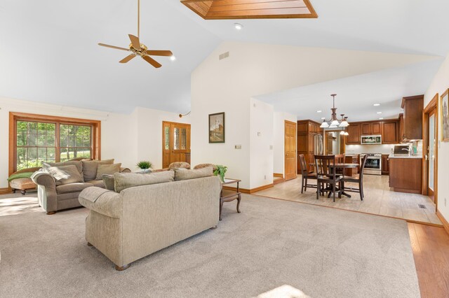 living room featuring high vaulted ceiling, baseboards, recessed lighting, a chandelier, and ceiling fan