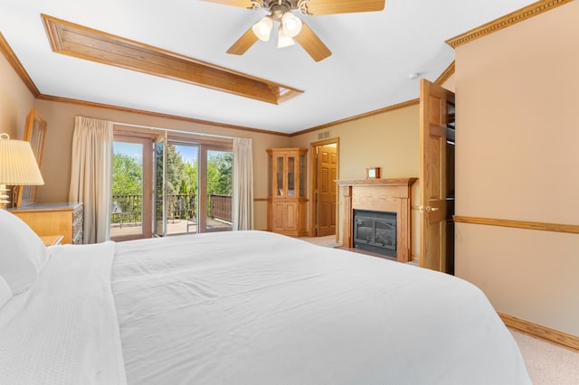 bedroom with access to exterior, crown molding, carpet floors, a fireplace with flush hearth, and ceiling fan