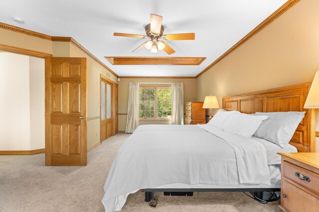 bedroom featuring ornamental molding, light carpet, and ceiling fan