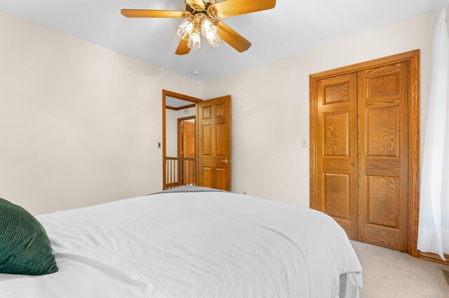 carpeted bedroom featuring ceiling fan
