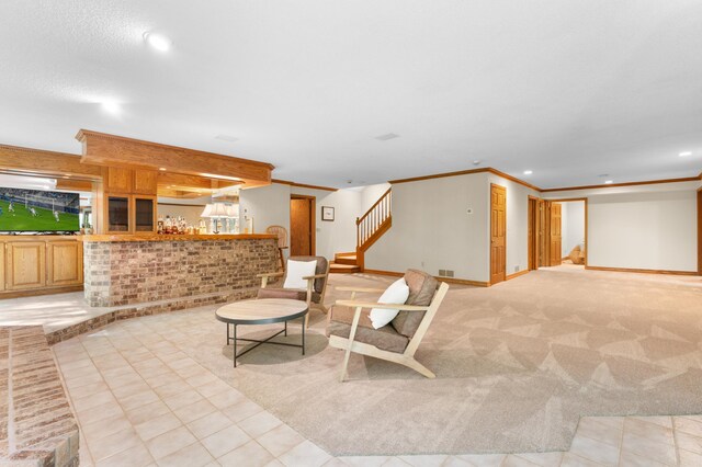 interior space with a dry bar, stairway, recessed lighting, ornamental molding, and baseboards