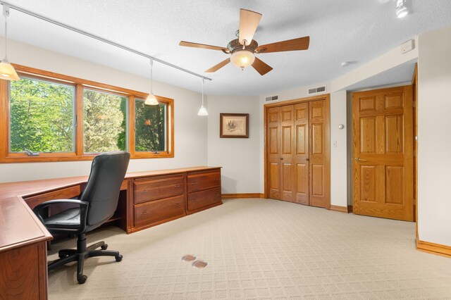office featuring ceiling fan, light colored carpet, and baseboards