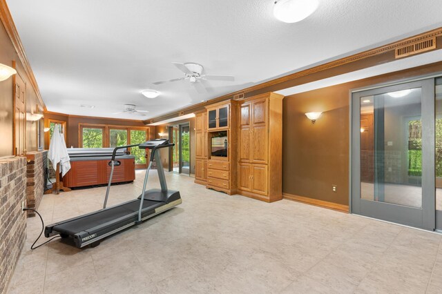 workout area with ornamental molding, ceiling fan, and baseboards