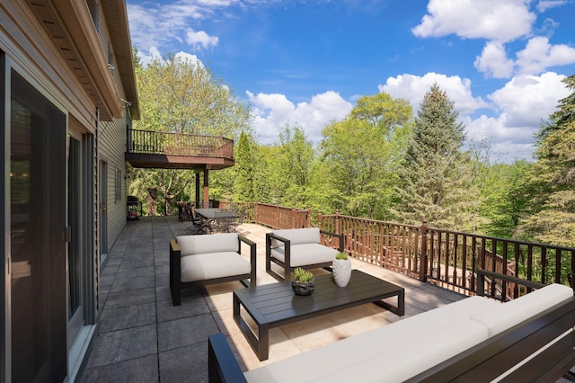 view of patio with an outdoor hangout area, outdoor dining area, and a wooden deck