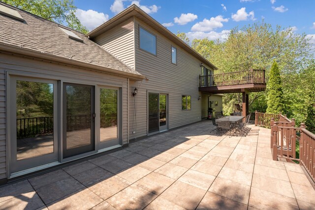 view of patio with outdoor dining area and a deck