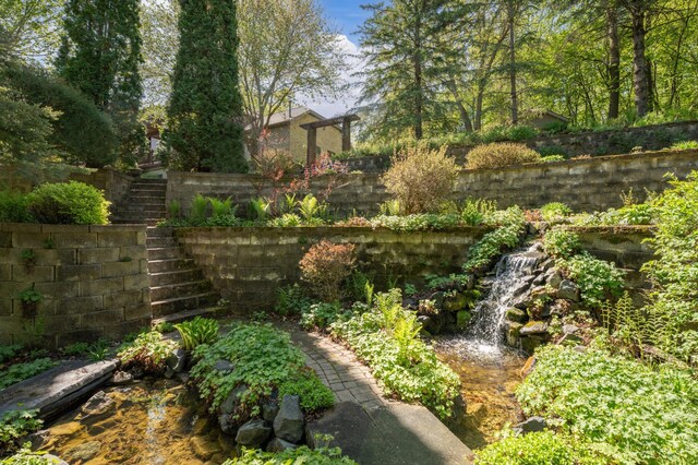 view of yard with fence and stairway