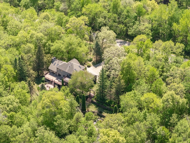 view of subject property with a heavily wooded area
