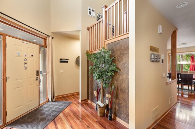 entryway featuring visible vents, baseboards, wood finished floors, and recessed lighting
