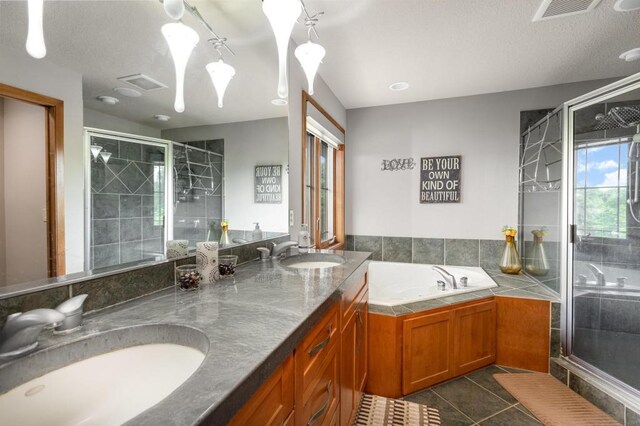 full bathroom with tile patterned flooring, visible vents, a sink, and a stall shower