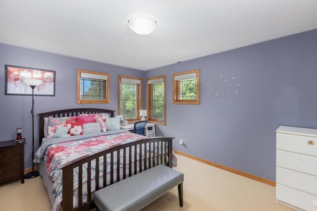 bedroom featuring baseboards and carpet flooring