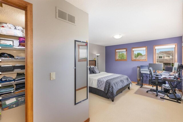 carpeted bedroom with visible vents