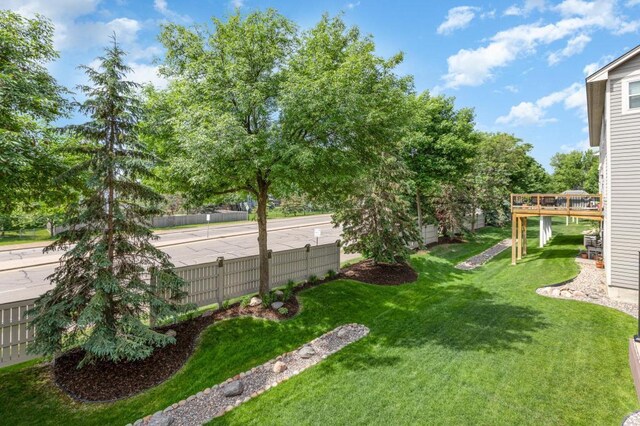 view of yard with fence and a deck