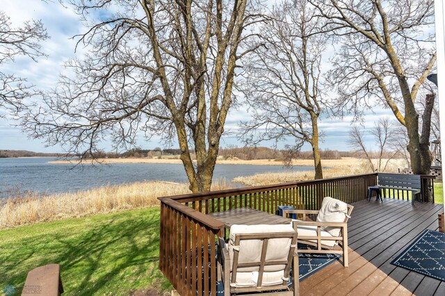 wooden deck featuring a yard and a water view