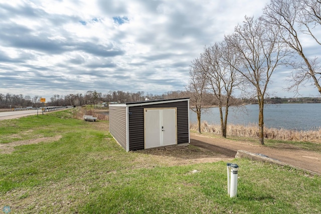 view of shed with a water view