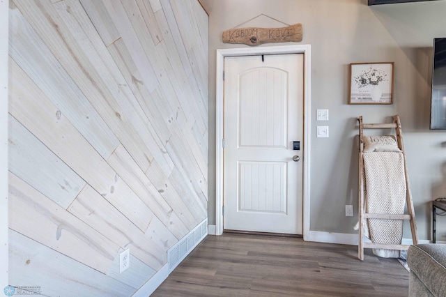 entryway featuring baseboards, visible vents, and wood finished floors