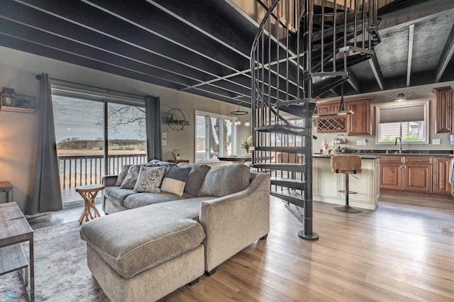living area featuring light wood-style floors and a water view