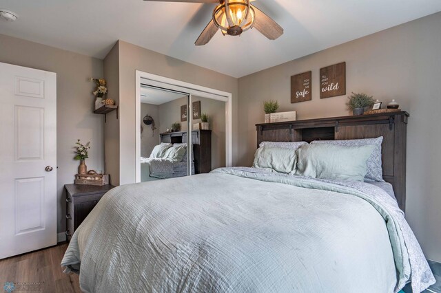 bedroom featuring ceiling fan, a closet, and wood finished floors
