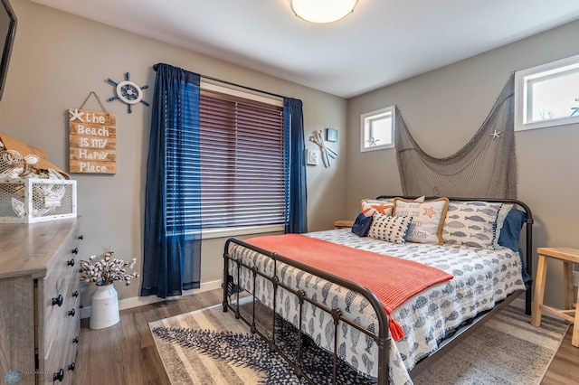 bedroom featuring baseboards and wood finished floors