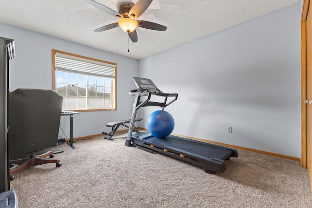 workout area featuring baseboards, ceiling fan, a textured ceiling, and carpet