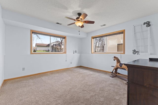 unfurnished office with visible vents, carpet, and plenty of natural light