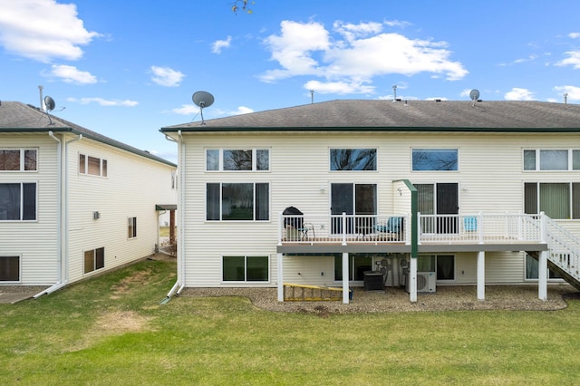 back of property featuring a deck, cooling unit, a yard, and ac unit