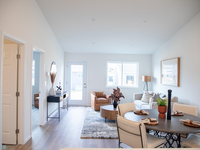 living room featuring light wood-style floors and vaulted ceiling