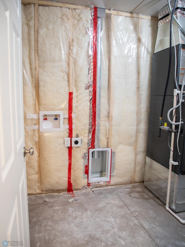 unfinished basement featuring heating unit