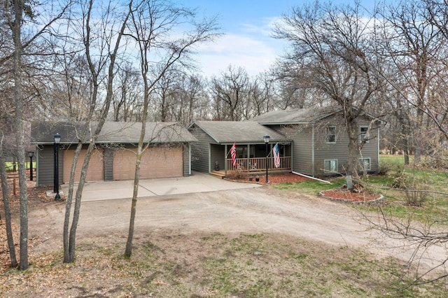 13229 Fremont Ave, Zimmerman, MN 55398 - view of front facade featuring driveway, a porch, and a shingled roof