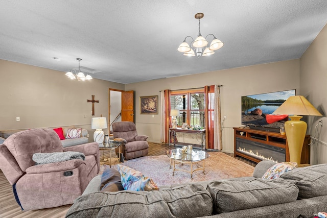13229 Fremont Ave, Zimmerman, MN 55398 - living room with a chandelier, wood finished floors, and a textured ceiling
