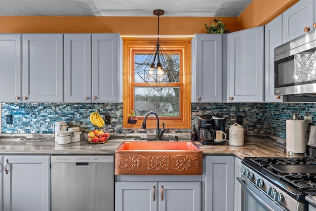 13229 Fremont Ave, Zimmerman, MN 55398 - kitchen with stainless steel appliances, decorative backsplash, light countertops, and pendant lighting