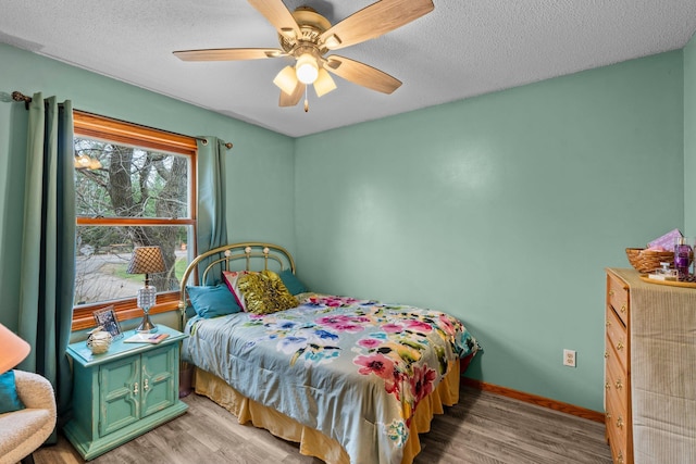 13229 Fremont Ave, Zimmerman, MN 55398 - bedroom featuring light wood-type flooring, a textured ceiling, and a ceiling fan