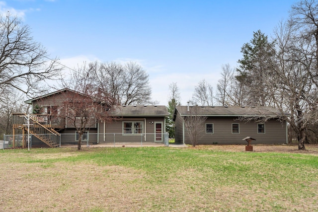 13229 Fremont Ave, Zimmerman, MN 55398 - rear view of property featuring stairway, a wooden deck, a lawn, and a patio area