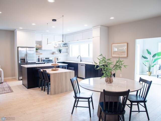 dining area featuring recessed lighting and light wood-style floors