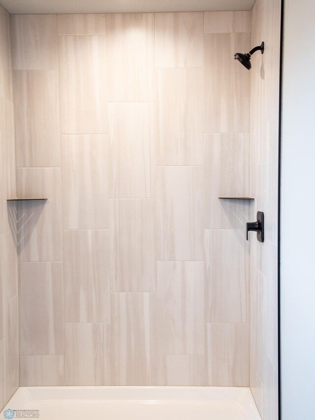 bathroom with a tile shower