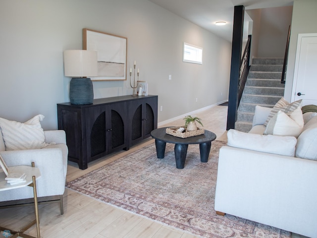 1479 66th Ave S, Fargo, ND 58104 - living area with stairway, wood finished floors, and baseboards