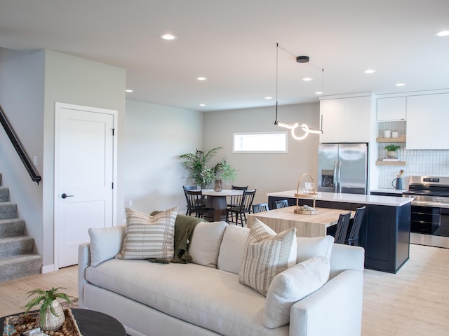1479 66th Ave S, Fargo, ND 58104 - living room featuring stairs, light wood-type flooring, and recessed lighting