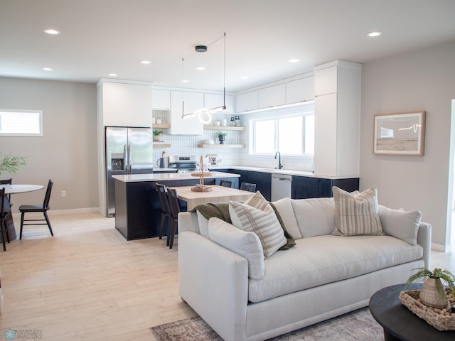 1479 66th Ave S, Fargo, ND 58104 - living room with light wood-style flooring, recessed lighting, and baseboards