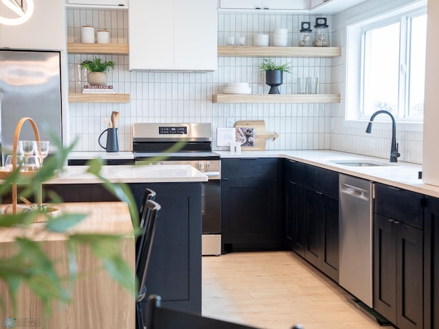 1479 66th Ave S, Fargo, ND 58104 - kitchen with open shelves, stainless steel appliances, a sink, tasteful backsplash, and dark cabinetry
