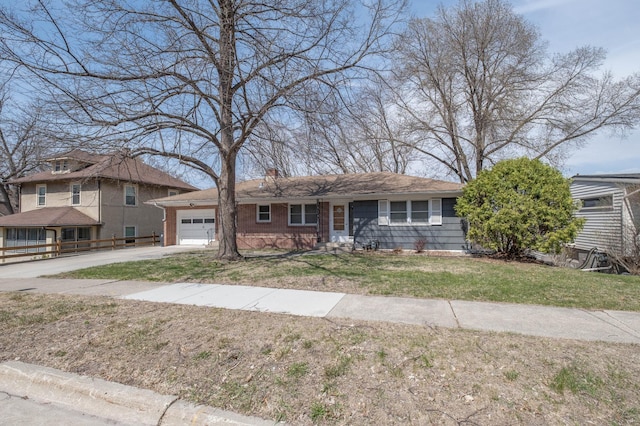 view of front of house featuring concrete driveway, a front lawn, a chimney, and a garage