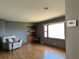 unfurnished room with wood finished floors