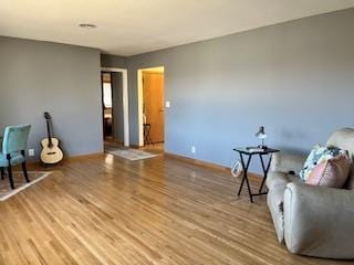 living area featuring wood finished floors and baseboards