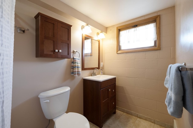 bathroom with tile patterned flooring, toilet, and vanity