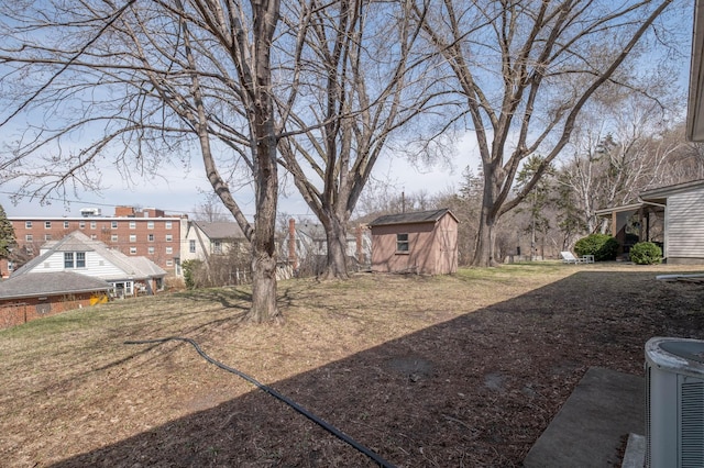 view of yard featuring central AC, an outdoor structure, and a shed