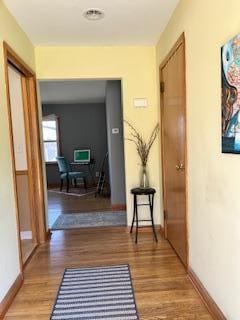 hall with wood finished floors and baseboards