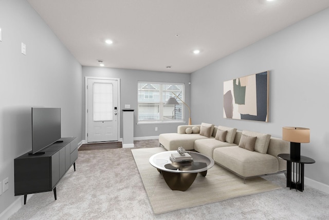 living area featuring recessed lighting, baseboards, and carpet