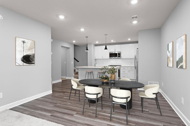 dining room featuring recessed lighting, baseboards, and wood finished floors