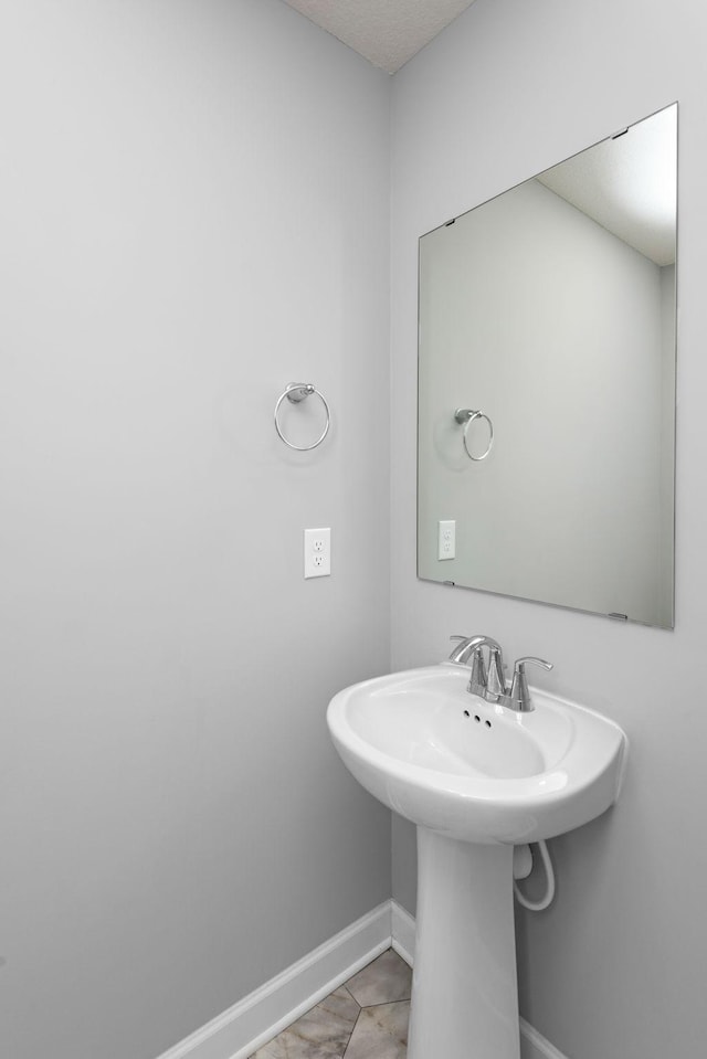 bathroom featuring baseboards and tile patterned floors