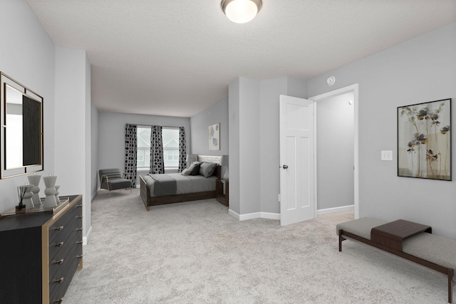 bedroom featuring baseboards, a textured ceiling, and light carpet
