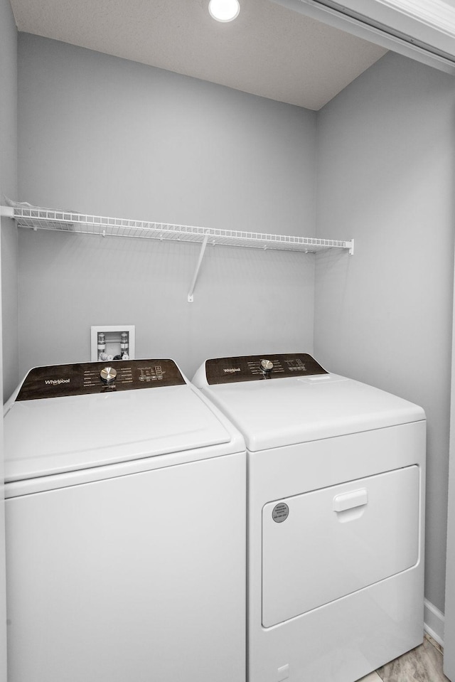 clothes washing area with laundry area, light wood-style floors, baseboards, recessed lighting, and washer and clothes dryer