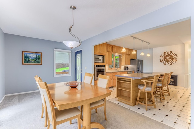 3310 Lake Johanna Blvd, Arden Hills, MN 55112 - dining room with rail lighting, plenty of natural light, light colored carpet, and baseboards